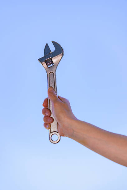 istock Monkey wrench in the background of blue sky 1321487648