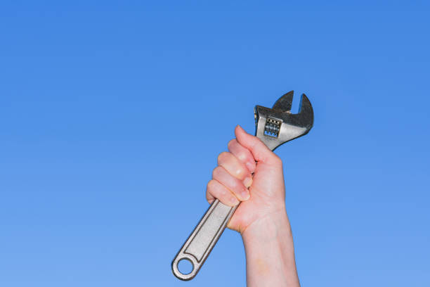 istock Monkey wrench in the background of blue sky 1321487649