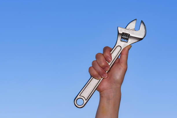 istock Monkey wrench in the background of blue sky 1321487650