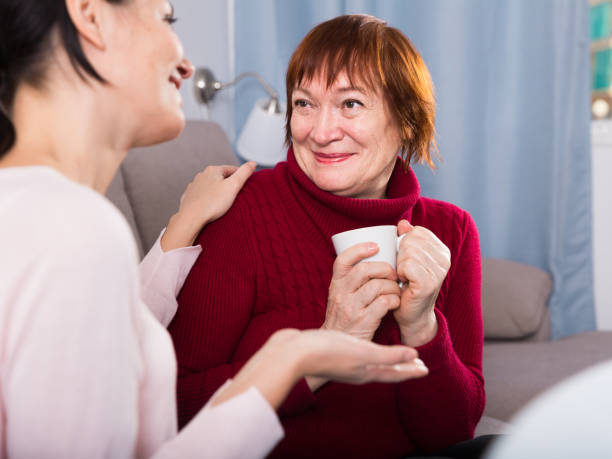 istock Mature woman with daughter talking at sofa 1321489569