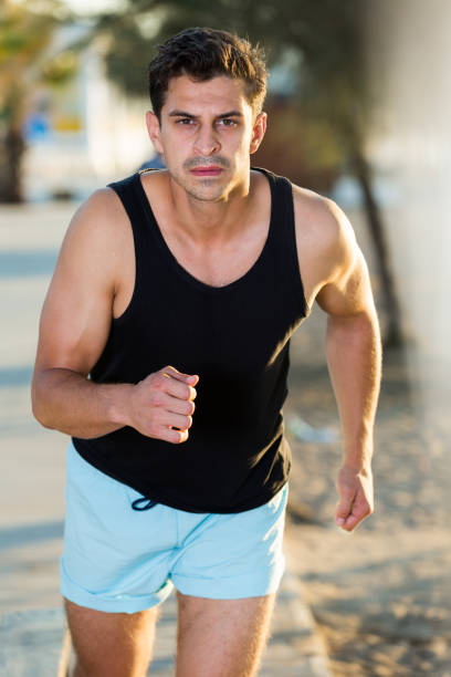 istock Man running along embankment 1321489670