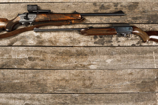 istock Hunting weapon on dark wooden backgorund, top view 1321490760