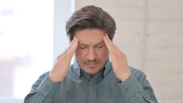 istock Portrait of Middle Aged Man having Headache 1321491001
