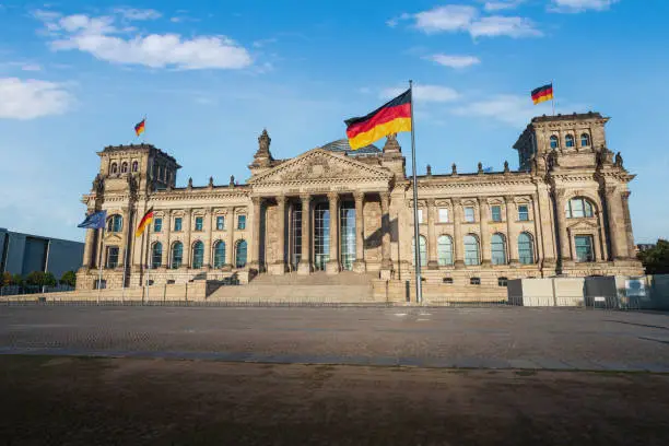 German Parliament (Bundestag) - Reichstag Building with German Flag - Berlin, Germany - Text says: To the German People