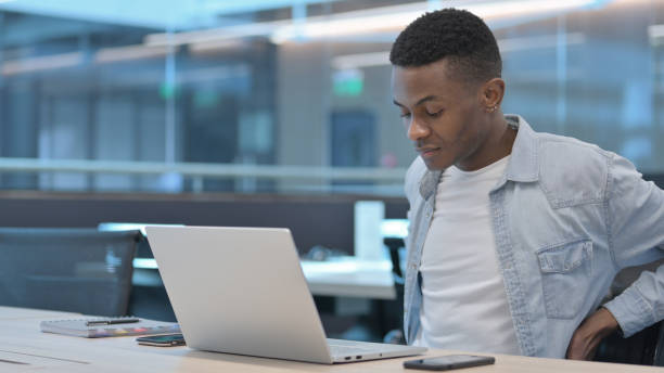 istock African Man with Laptop having Back Pain 1321492221