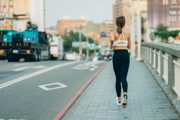 istock Woman jogging on city 1321492352