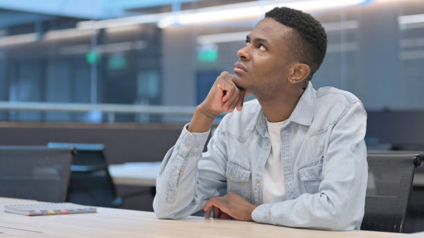 istock African Man Sitting in Office Thinking 1321492535