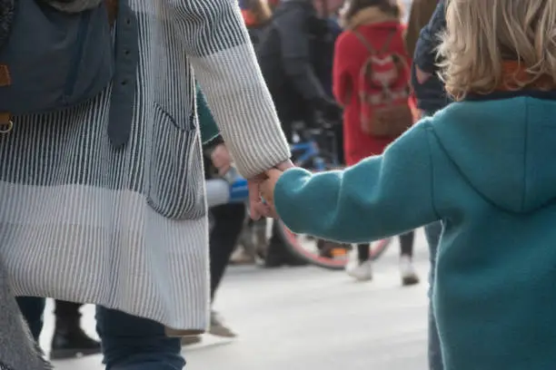 child and mother holding hands, sign of trust and intimacy