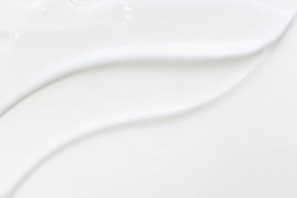 istock White face cream swirl swatch isolated. Body lotion drop. Cosmetic makeup product sample on white background. 1321492995