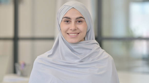 istock Young Woman Smiling at Camera 1321494248