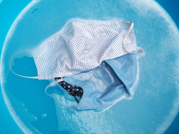 istock soaking dirty face mask in detergent foam bubble 1321494716