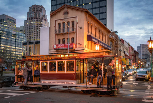 passengers riding a traditional cable car in san francisco - nob hill imagens e fotografias de stock