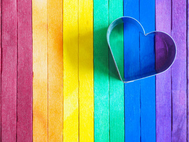 istock Heart shape frame on colorful wooden background. 1321495772