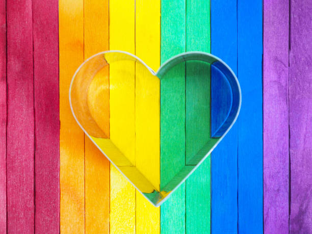 istock Heart shape frame on colorful wooden background. 1321495948