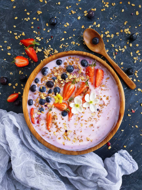 istock yogurt, granola, strawberry, blueberry on a concrete background 1321497113