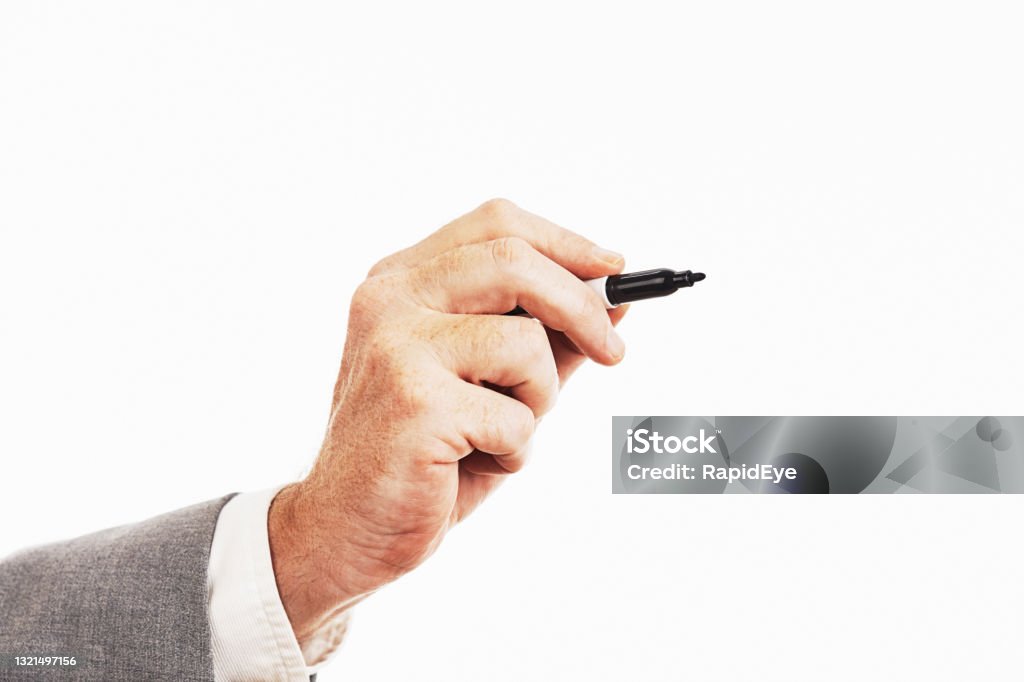 Hand of businessman wearing suit holds a felt-tip pen poised to write Man's hand holding a permanent marker or whiteboard marker. Hand Stock Photo