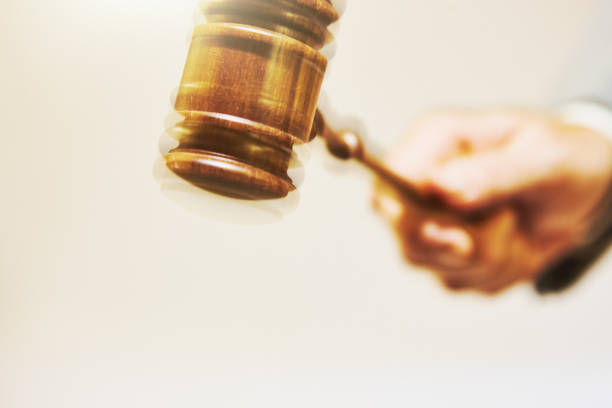 istock Gavel with motion blur being hammered down by a judge or auctioneer wearing a suit 1321497176