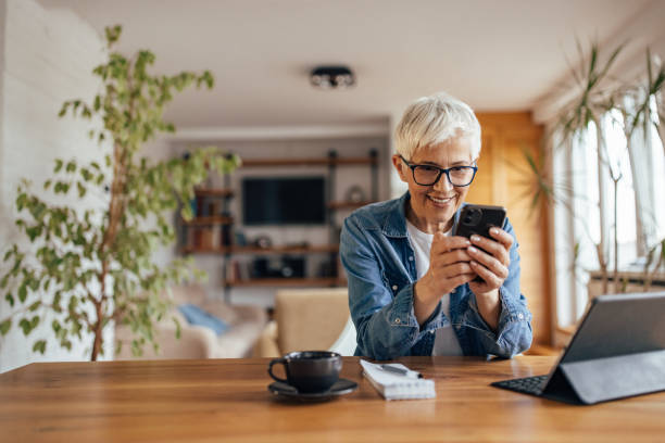 istock Mature woman, checking her messages, at home office. 1321497180