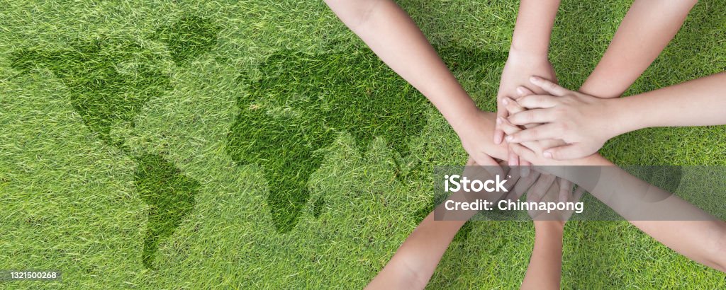 Global community teamwork, CSR and ESG environmental energy saving collaboration among young children with partnership hands stack together on green background for sustainable development goal concept Sustainable Lifestyle Stock Photo