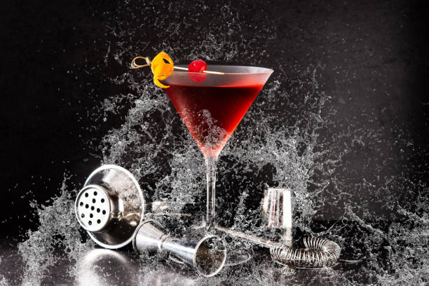 istock Traditional Manhattan cocktail with cherry splashing water 1321500391