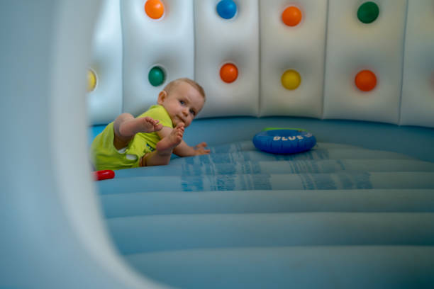 istock Child on colorful playground trampoline 1321501523