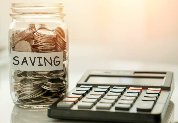 istock money saving for emergency money and calculator.Saving for emergency concept. 1321504003