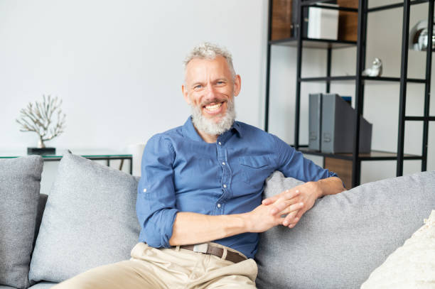 istock Handsome optimistic mature man staring at the camera with cheerful toothy smile 1321505344