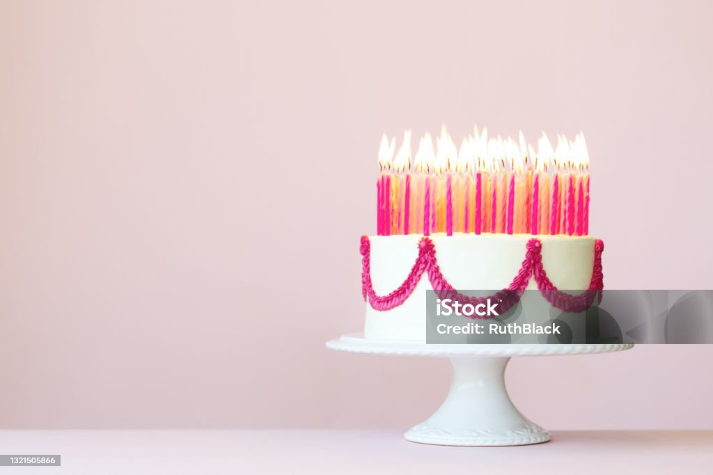 Birthday cake with lots of candles Birthday cake with lots of pink birthday candles on a pink background Birthday Cake Stock Photo