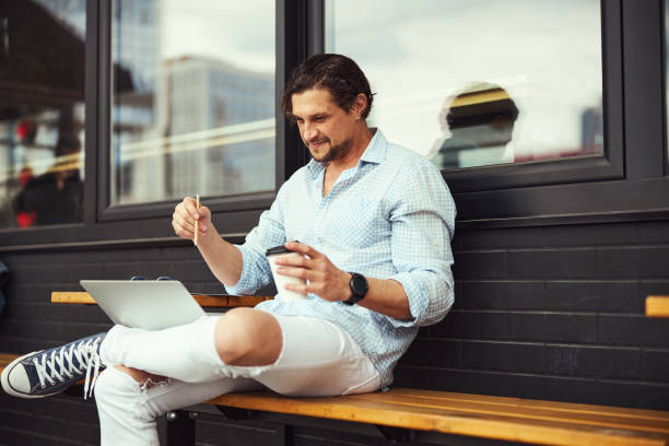 istock Attentive brunette man staring at screen of his laptop 1321507263