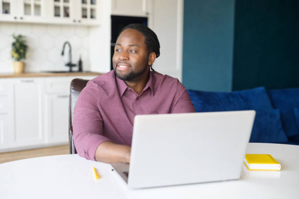 istock Smart and confident African-American freelancer is using laptop for work on the distance 1321507542