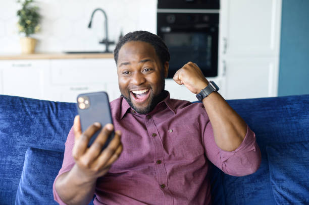 istock Hilarious African-American man celebrating victory 1321508668