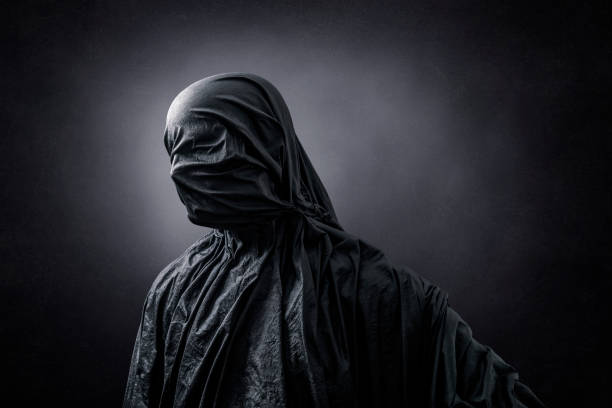 istock Creepy figure over dark misty background 1321509418