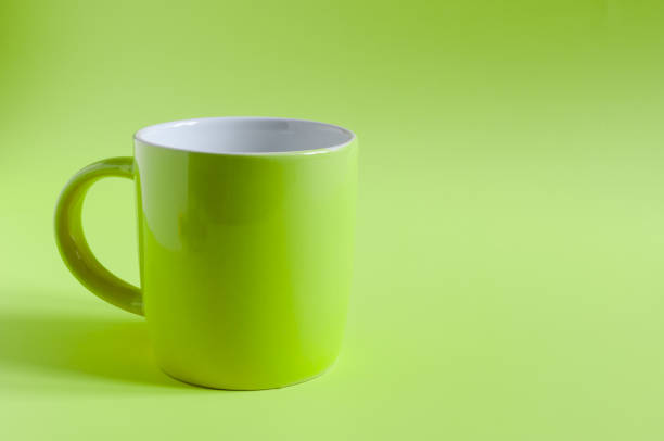 istock Abstract background green ceramic mug on green background close-up, concept. Bright green ceramic kopi space mug 1321509551