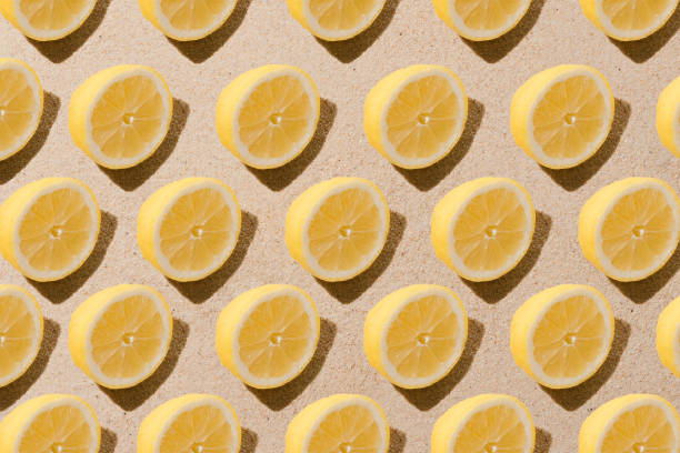 istock Minimal nature pattern with lemon slices. Sand background. Summer fruit concept. Flat lay social 1321512993