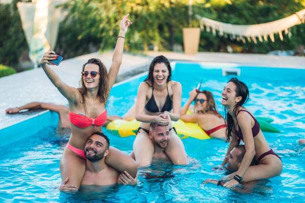 istock Selfie with friends at a poolside party 1321516336