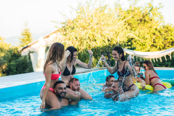 istock Piggyback fun in swimming pool 1321517143
