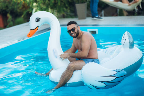 istock Carefree man on float swan 1321519638