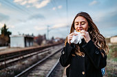 Woman eating while waiting train