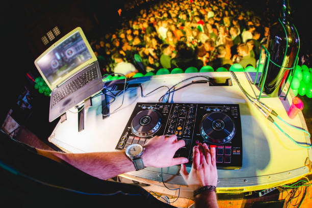 istock DJ playing and mixing music at party 1321521712