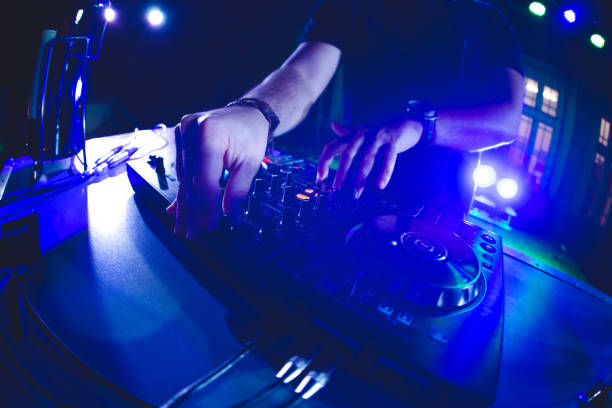 istock DJ playing and mixing music at party 1321521900