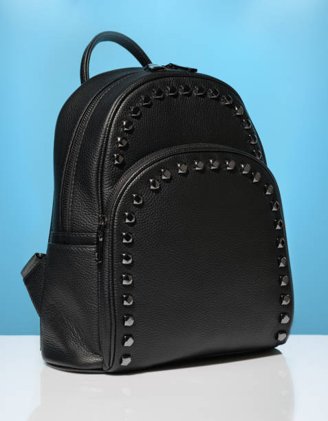 istock Black leather casual backpack on blue background 1321526927
