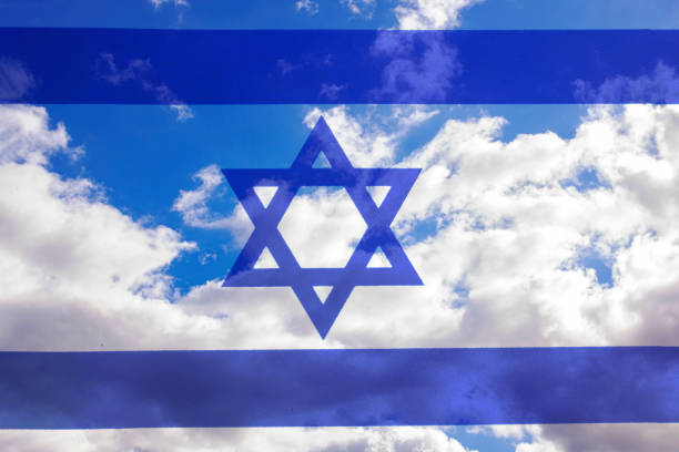 Israel flag on a blue sky background close up