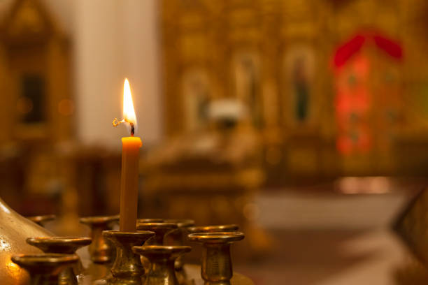istock One candle on a stand in a church 1321528392
