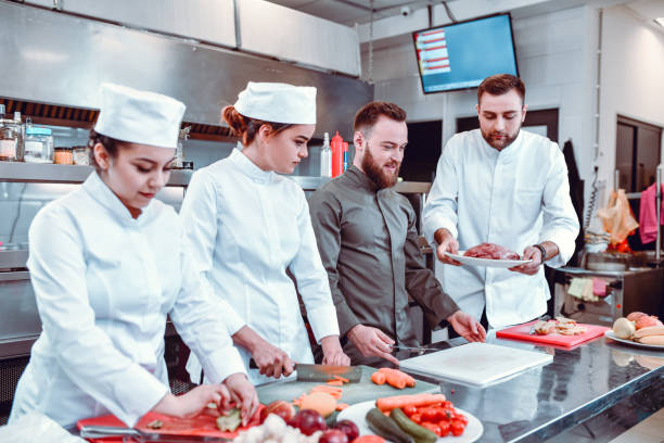 istock Focused Cooks Ready For Start Of Kitchen Competition 1321531424