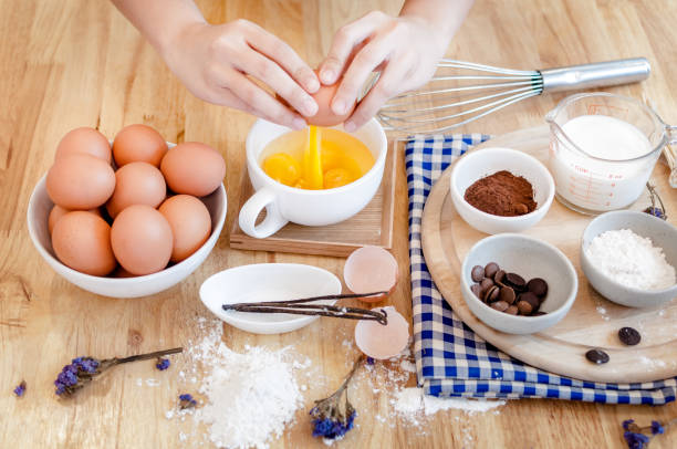istock Man in the kitchen cooking a dough. Hands breaks an egg into a bowl ,hands pouring bitten egg 1321534293