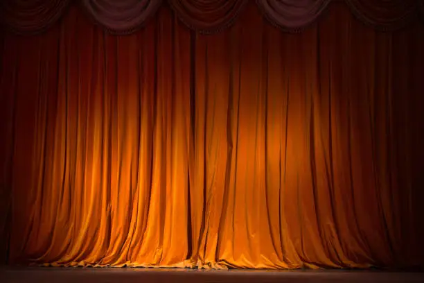 Photo of red-brown curtain on the stage with wooden floor and theater backstage, background, texture