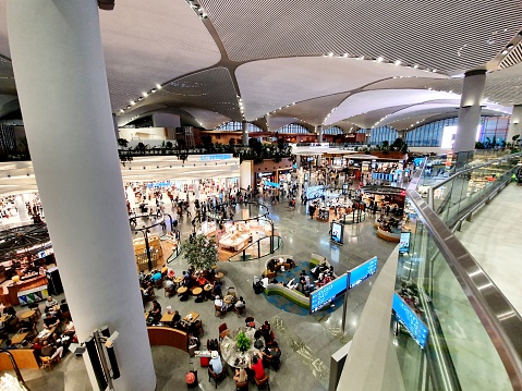 The New Istanbul Airport (IST) was opened on 6 April 2019. The new Airport can accommodate 200 million passengers a year. The Image shows the Main Hall with shops, restaurants and coffe shops.