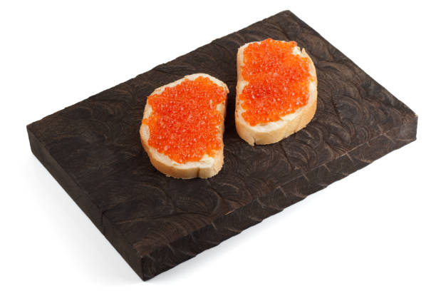 open-face sandwiches with salmon roe on wooden board - plank bread caviar close up imagens e fotografias de stock