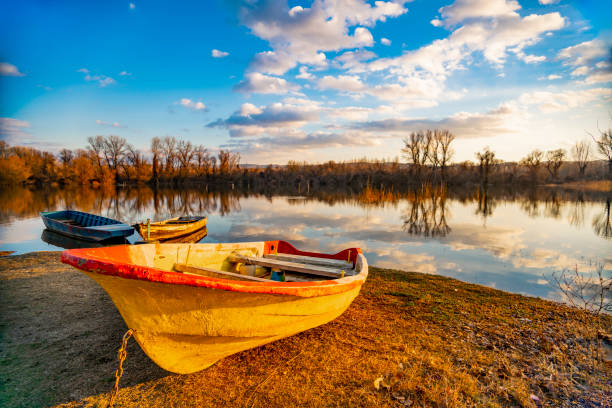 View at old yellow boat on the ground by the lake