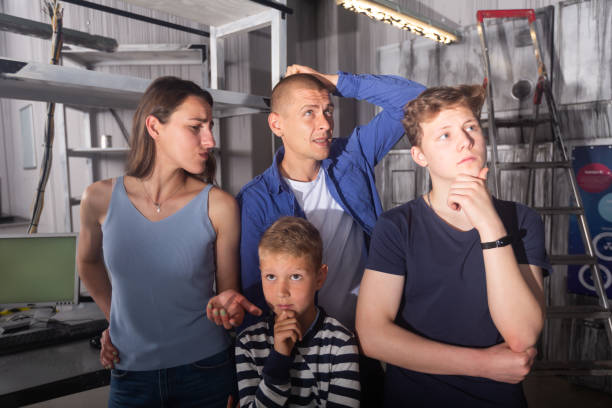 istock Interested family contemplating solving conundrums in escape room 1321539936